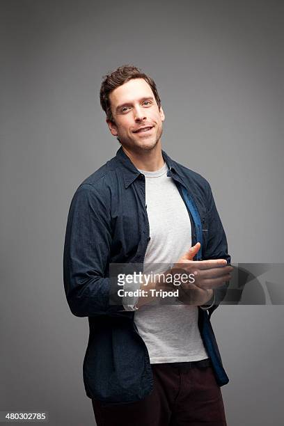 man rubbing hands smiling - three quarter length stock pictures, royalty-free photos & images