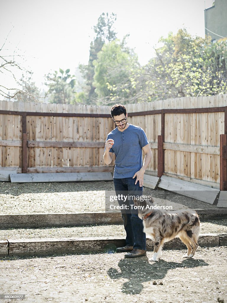 Man playing with his dog in backyard