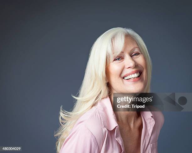 mature woman laughing - blonde hair blue eyes stock pictures, royalty-free photos & images