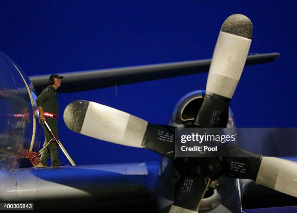 Crew member steps off a Royal Australian Air Force AP-3C Orion upon its return from a search for Malaysian Airlines flight MH370 over the Indian...