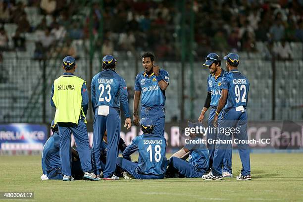 The Sri Lankan team waits after play was halted due to a power failure during the Sri Lanka v The Netherlands match at the ICC World Twenty20...