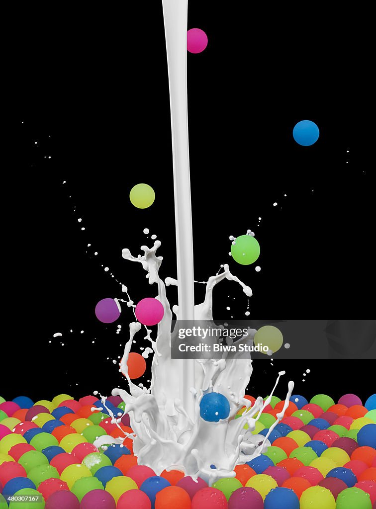 Colorful bouncing balls with white paint splash