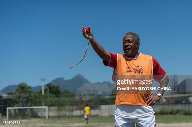 Formber Brazilian football player Jair Ventura Filho aka Jairzinho coaches youngsters during a project to find a talent at Varginha shantytown in Rio...
