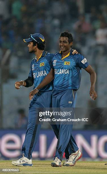 Dinesh Chandimal and Ajantha Mendis of Sri Lanka celebrate another wicket during the Sri Lanka v The Netherlands match at the ICC World Twenty20...