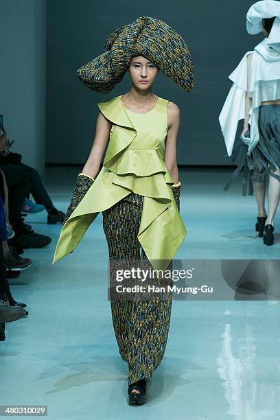 Model showcases designs on the runway during the Singapore Designers Showcase show as part of Seoul Fashion Week A/W 2014 on March 24 in Seoul, South...