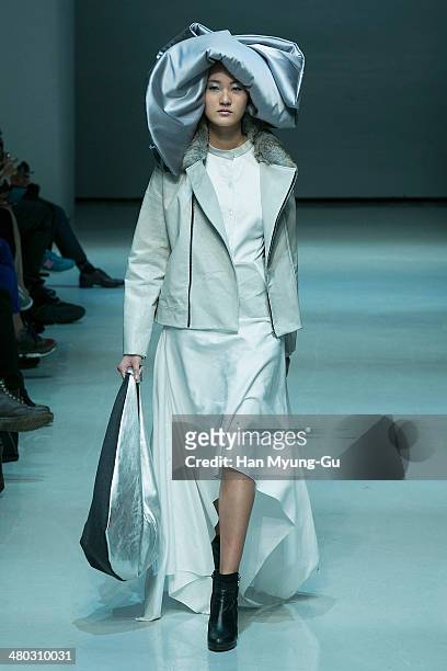 Model showcases designs on the runway during the Singapore Designers Showcase show as part of Seoul Fashion Week A/W 2014 on March 24 in Seoul, South...