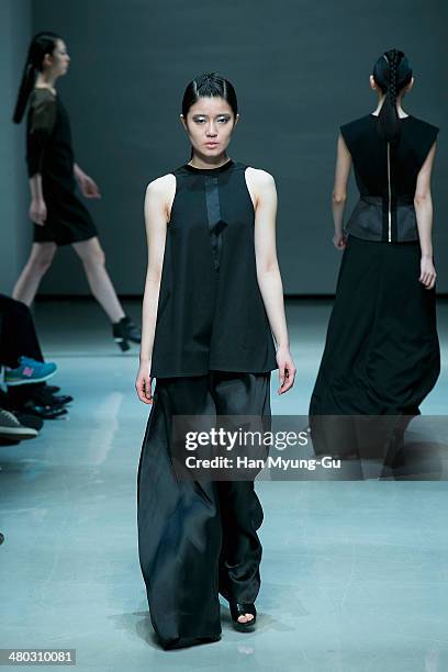 Model showcases designs on the runway during the Singapore Designers Showcase show as part of Seoul Fashion Week A/W 2014 on March 24 in Seoul, South...