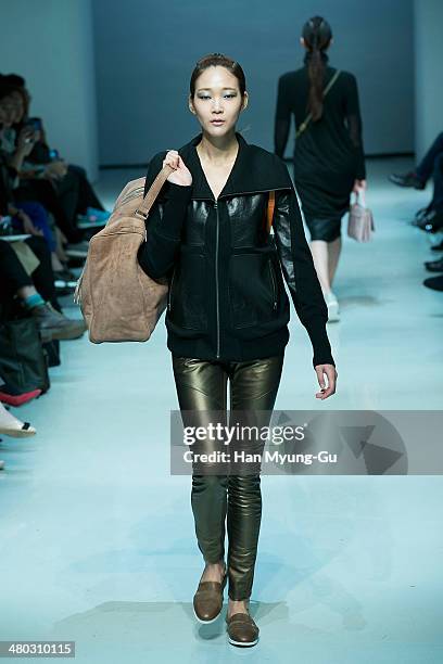 Model showcases designs on the runway during the Singapore Designers Showcase show as part of Seoul Fashion Week A/W 2014 on March 24 in Seoul, South...