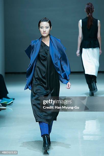 Model showcases designs on the runway during the Singapore Designers Showcase show as part of Seoul Fashion Week A/W 2014 on March 24 in Seoul, South...