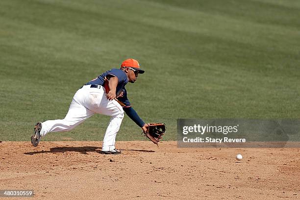 Cesar Izturis of the Houston Astros fields a ball in the fifth inning of a spring training game against the Miami Marlins at Osceola County Stadium...