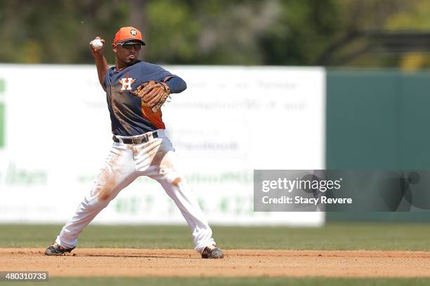 Cesar Izturis of the Houston Astros makes a throw to first base in the fourth inning of a spring training game against the Miami Marlins at Osceola...