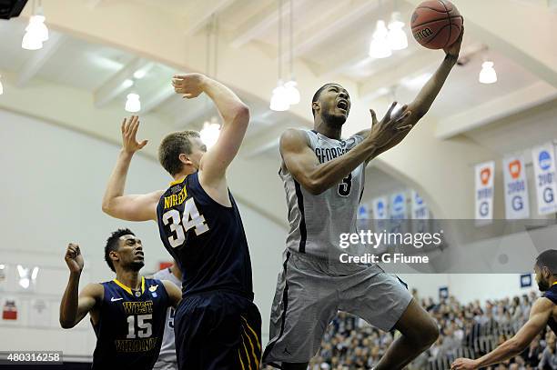 Mikael Hopkins of the Georgetown Hoyas drives to the hoop against the West Virginia Mountaineers during the First Round of the NIT at McDonough Arena...