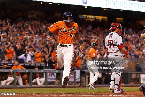 Justin Maxwell of the San Francisco Giants scores a run past Carlos Ruiz of the Philadelphia Phillies during the fourth inning at AT&T Park on July...