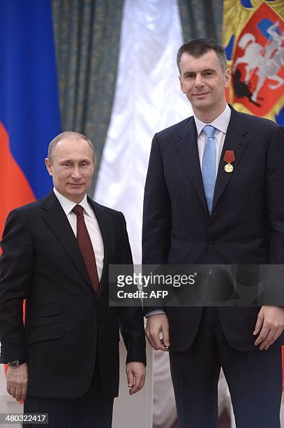 Russian President Vladimir Putin poses for a photo with businessman-turned-politician Mikhail Prokhorov during an awarding ceremony at the Kremlin in...