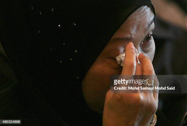 Family member of a victim cries during a prayer at the first anniversary of the crash of Malaysia Airlines flight MH17 which was shot down in eastern...