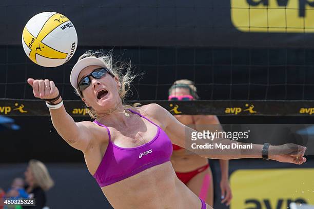 Kerri Walsh-Jennings dives to recover a ball as April Ross looks on at the AVP New Orleans Open at Laketown on May 24, 2015 in Kenner, Louisiana.