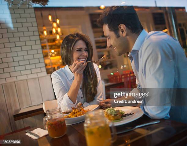 couple in a romantic dinner at a restaurant - romantic dining stock pictures, royalty-free photos & images