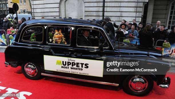 Muppets characters Miss Piggy, Kermit and Costantine arrive by London Taxi to the VIP screening of "The Muppets Most Wanted" at The Curzon Mayfair on...