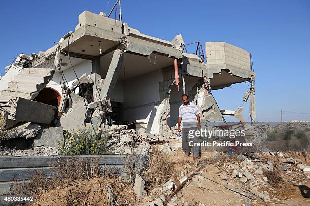 Palestinian Hamada Qudeh, inspecting their house which was destroyed during the 50-day Israeli war against Gaza in the summer of 2014, in the village...