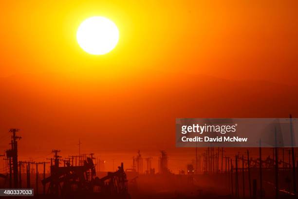 The sun rises over an oil field over the Monterey Shale formation where gas and oil extraction using hydraulic fracturing, or fracking, is on the...