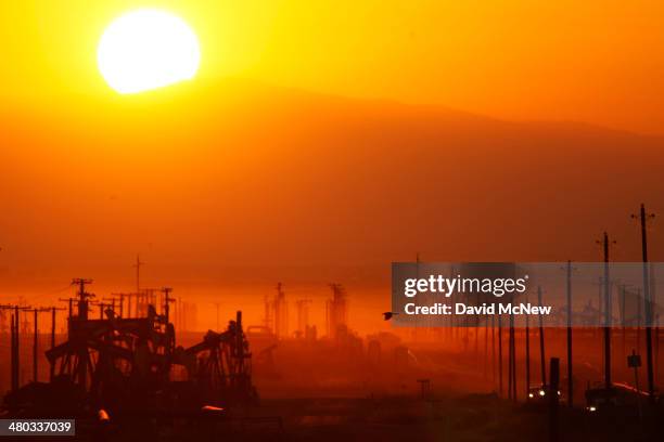 The sun rises over an oil field over the Monterey Shale formation where gas and oil extraction using hydraulic fracturing, or fracking, is on the...