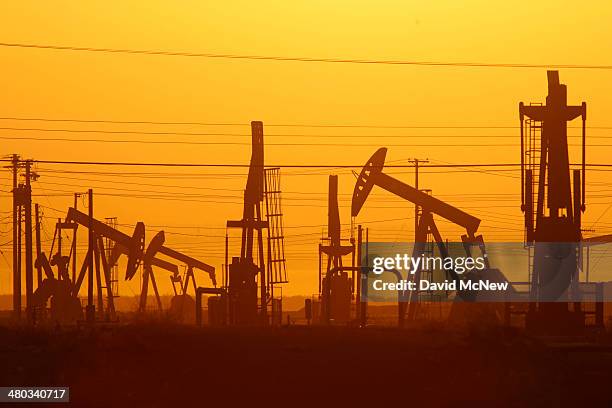 Pump jacks are seen at dawn in an oil field over the Monterey Shale formation where gas and oil extraction using hydraulic fracturing, or fracking,...