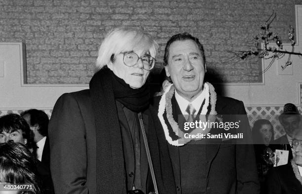 Andy Warhol with italian actor Alberto Sordi posing for a photo on December 31, 1986 in New York, New York.