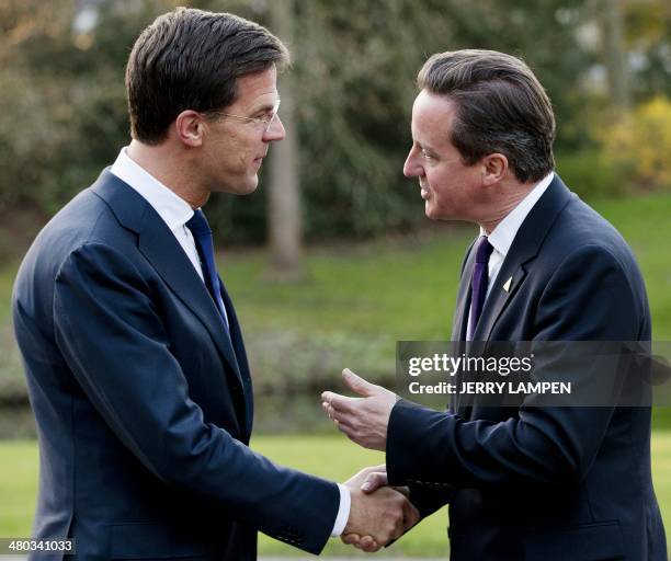 Dutch Prime Minister Mark Rutte greets British Prime Minister David Cameron upon his arrival for a G7 meeting at the official residence of the Dutch...