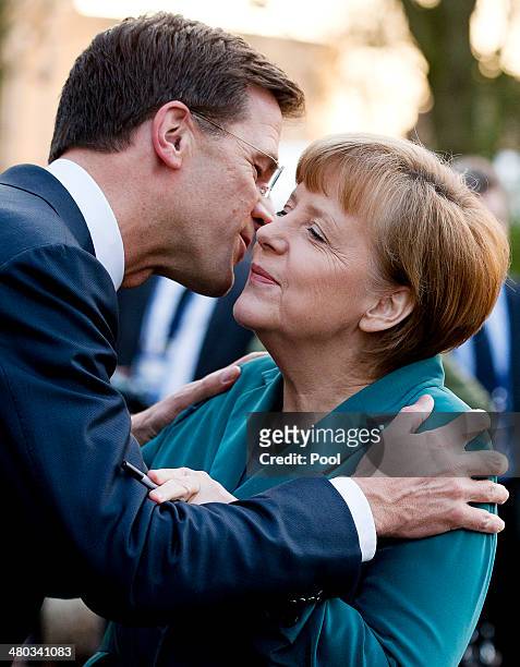 German Chancellor Angela Merkel is greeted by Dutch Prime Minister Mark Rutte upon arriving for a meeting of G7 leaders on March 24, 2014 in The...