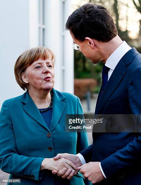 German Chancellor Angela Merkel is greeted by Dutch Prime Minister Mark Rutte upon arriving for a meeting of G7 leaders on March 24, 2014 in The...