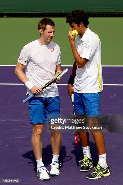 Jonathan Marray of Great Britain and Robin Hasse of Netherlands confer between points while playing Daniel Nestor of Canada and Nenad Zimonjic of...