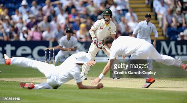 Stuart Broad and James Anderson of England field a shot from Chris Rogers of Australia during day four of the 1st Investec Ashes Test match between...