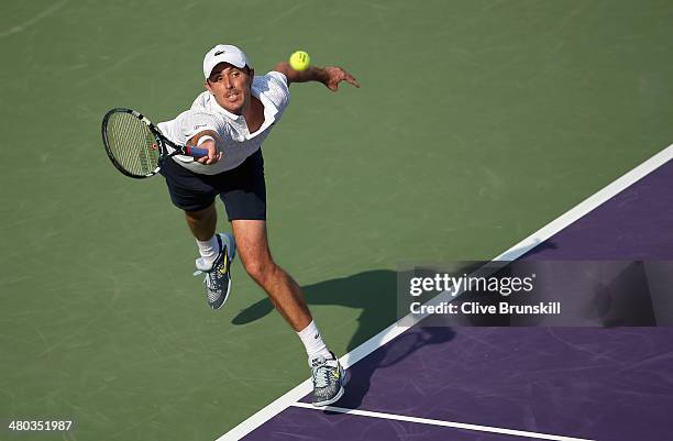 Edouard Roger-Vasselin of France stretches against Stanislas Wawrinka of Switzerland during their third round match during day 8 at the Sony Open at...