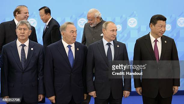 In this handout image supplied by Host Photo Agency/RIA Novosti, A group photograph of the SCO heads of state, the heads of observer states and...