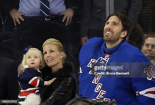 Henrik Lundqvist of the New York Rangers is joined by his wife Therese and daughter Charlise as the Rangers honor him prior to the game against the...