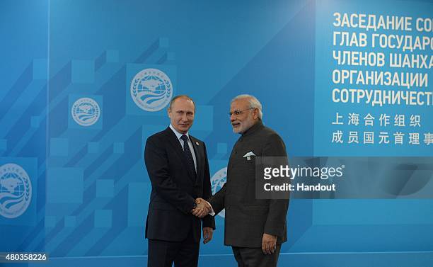 In this handout image supplied by Host Photo Agency/RIA Novosti, President of the Russian Federation Vladimir Putin, left, and Narendra Modi, Prime...