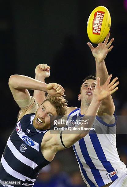 Dawson Simpson of the Cats and Todd Goldstein of the Kangaroos compete in the ruck during the round 15 AFL match between the North Melbourne...