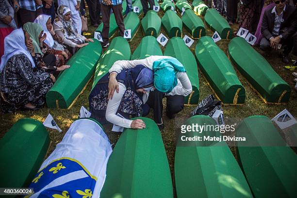 Women mourn over the coffin before the mass funeral for 136 newly-identified victims of the 1995 Srebrenica massacre attended by tens of thousands of...