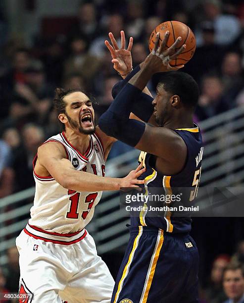 Joakim Noah of the Chicago Bulls defends against Roy Hibbert of the Indiana Pacers at the United Center on March 24, 2014 in Chicago, Illinois. NOTE...