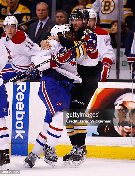Johnny Boychuk of the Boston Bruins throws down P.K. Subban of the Montreal Canadiens in the second period during the game at TD Garden on March 24,...