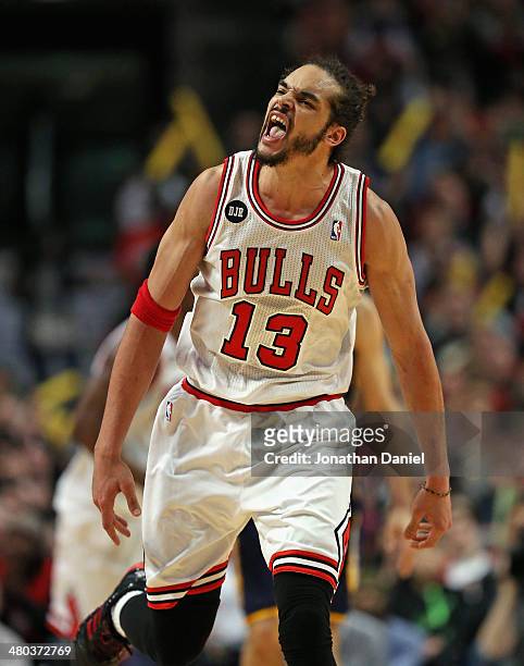 Joakim Noah of the Chicago Bulls celebrates a play against the Indiana Pacers at the United Center on March 24, 2014 in Chicago, Illinois. The Bulls...