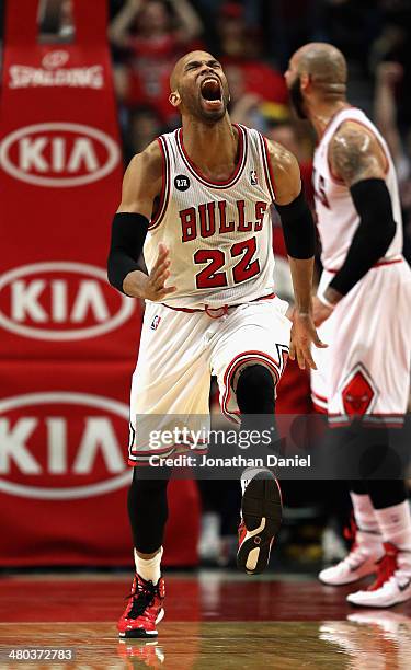 Taj Gibson of the Chicago Bulls celebrates after a dunk against the Indiana Pacers at the United Center on March 24, 2014 in Chicago, Illinois. The...