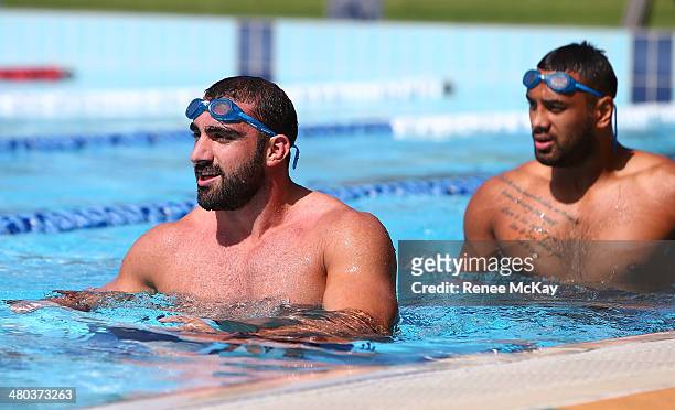 Tim Mannah and Kenny Edwards walk up the pool during a Parramatta Eels NRL recovery session at Pirtek Stadium on March 25, 2014 in Sydney, Australia.