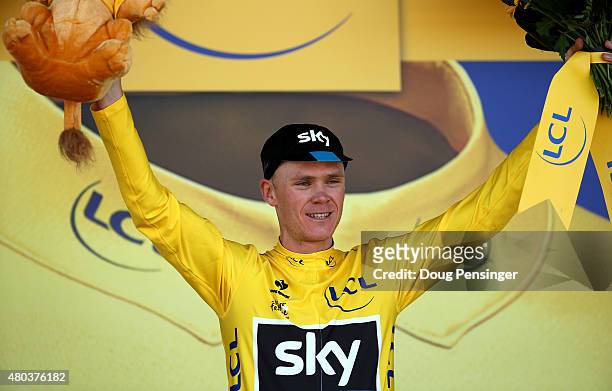 Chris Froome of Great Britain and Team Sky celebrates as he retains the yellow jersey following stage eight of the 2015 Tour de France, a 181.5km...