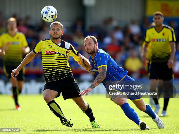 Almen Abdi of Watford tussels with Sean Rigg during the Pre Season Friendly match between AFC Wimbledon and Watford at The Cherry Red Records Stadium...