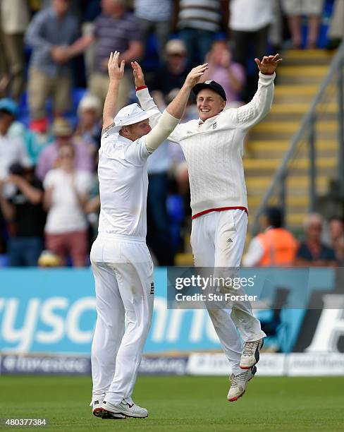 England fielder Joe Root celebrates with Ben Stokes after catching Australia batsman Josh Hazlewood to win the match during day four of the 1st...