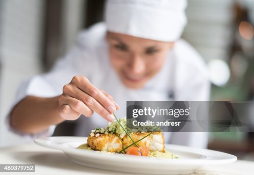 Cook decorating a plate Cook decorating a plate