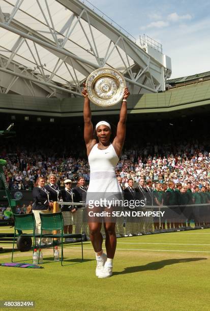 Player Serena Williams poses with the winner's trophy, the Venus Rosewater Dish, after her women's singles final victory over Spain's Garbine...