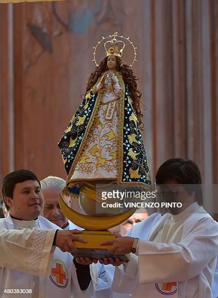 Statue of the Virgin mary is carried at the Marian Shrine of Caacupe, 50 km from Asuncion, before Pope Francis delivers mass to hundreds of thousands...