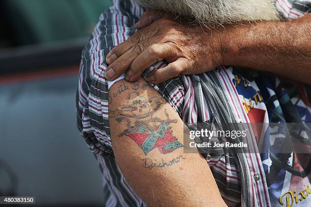 Rickey E. Blount displays a Confederate flag tattoo as he participates in a rally to show support for the American and Confederate flags on July 11,...